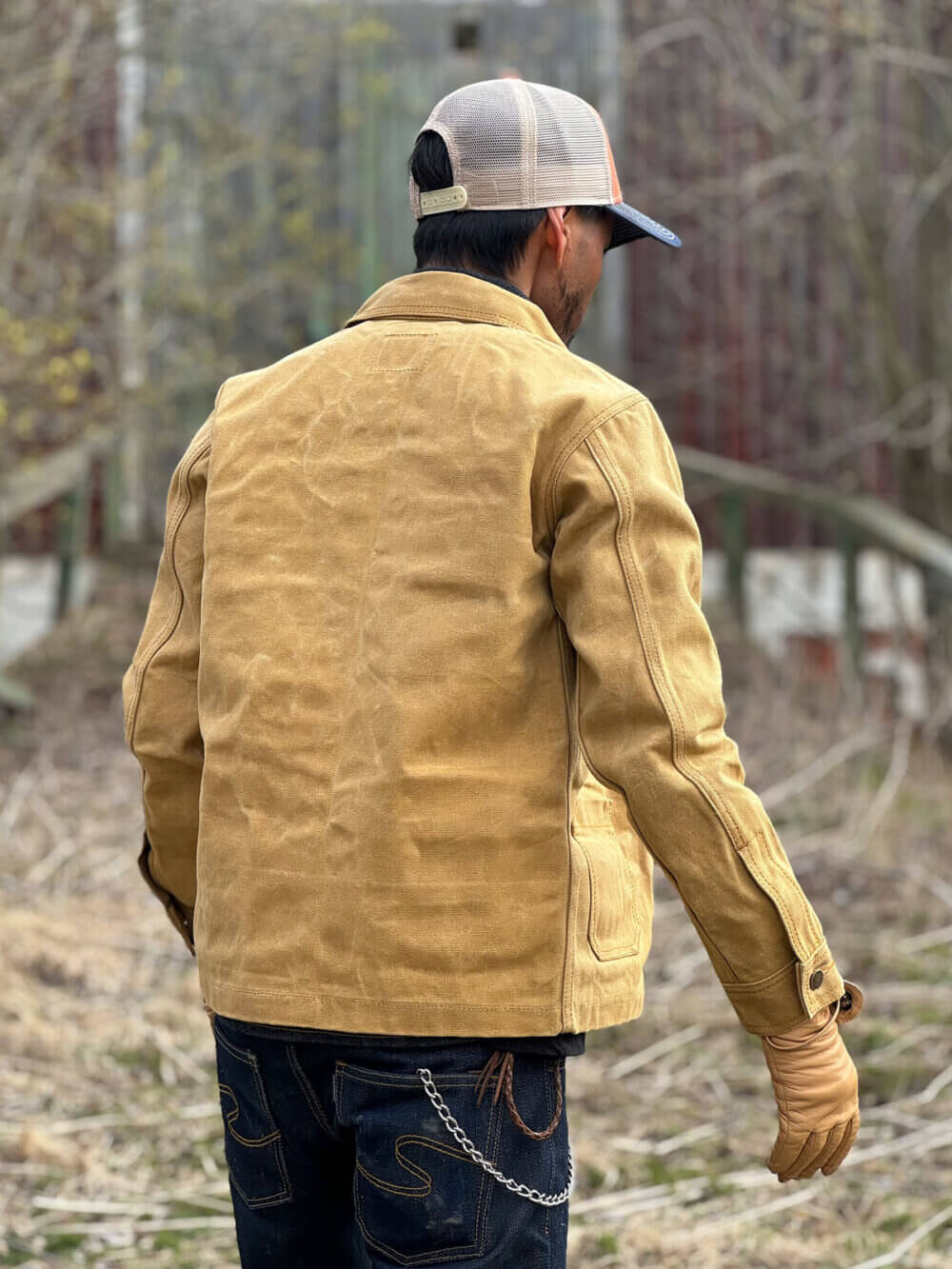 Back view of custom-made sand canvas chore jacket with metal buttons.